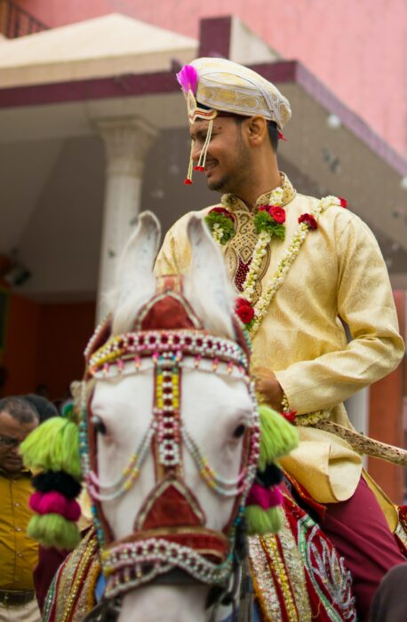 Groom on white horse