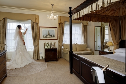 Orton-Hall-Bride-in-bedroom