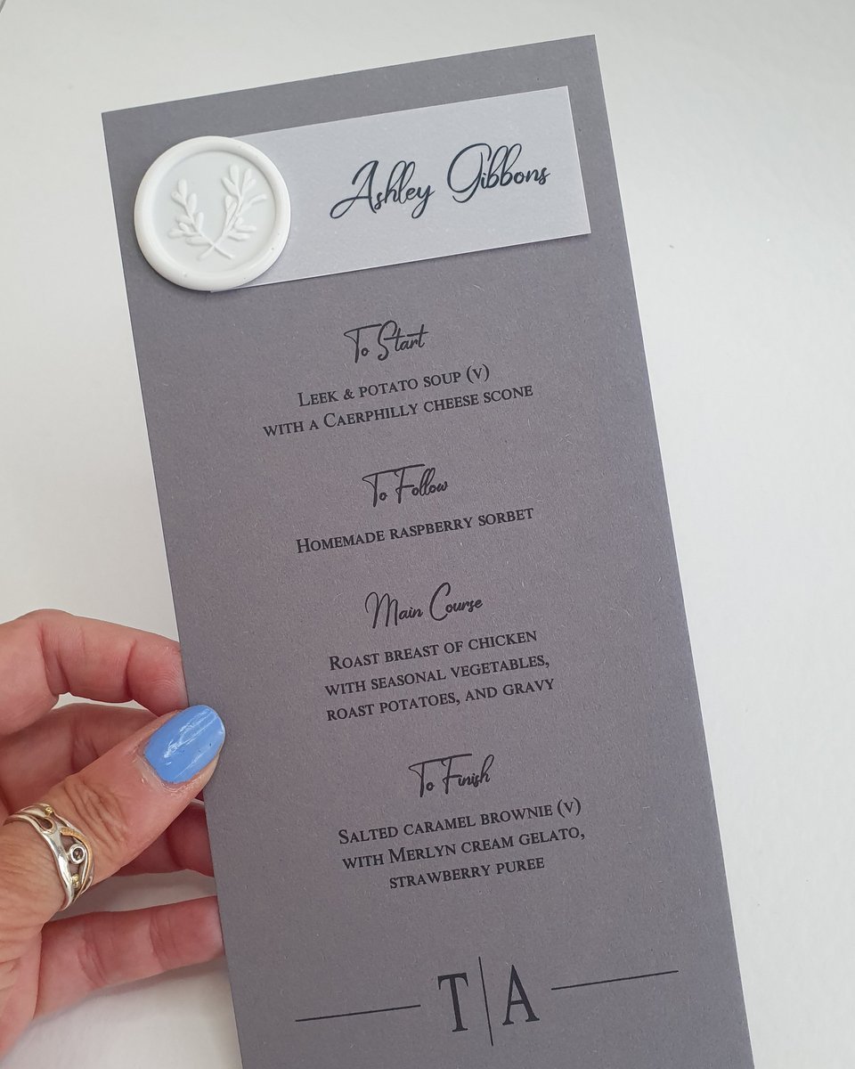grey modern mongram personalised menu with white wax seal and vellum tag