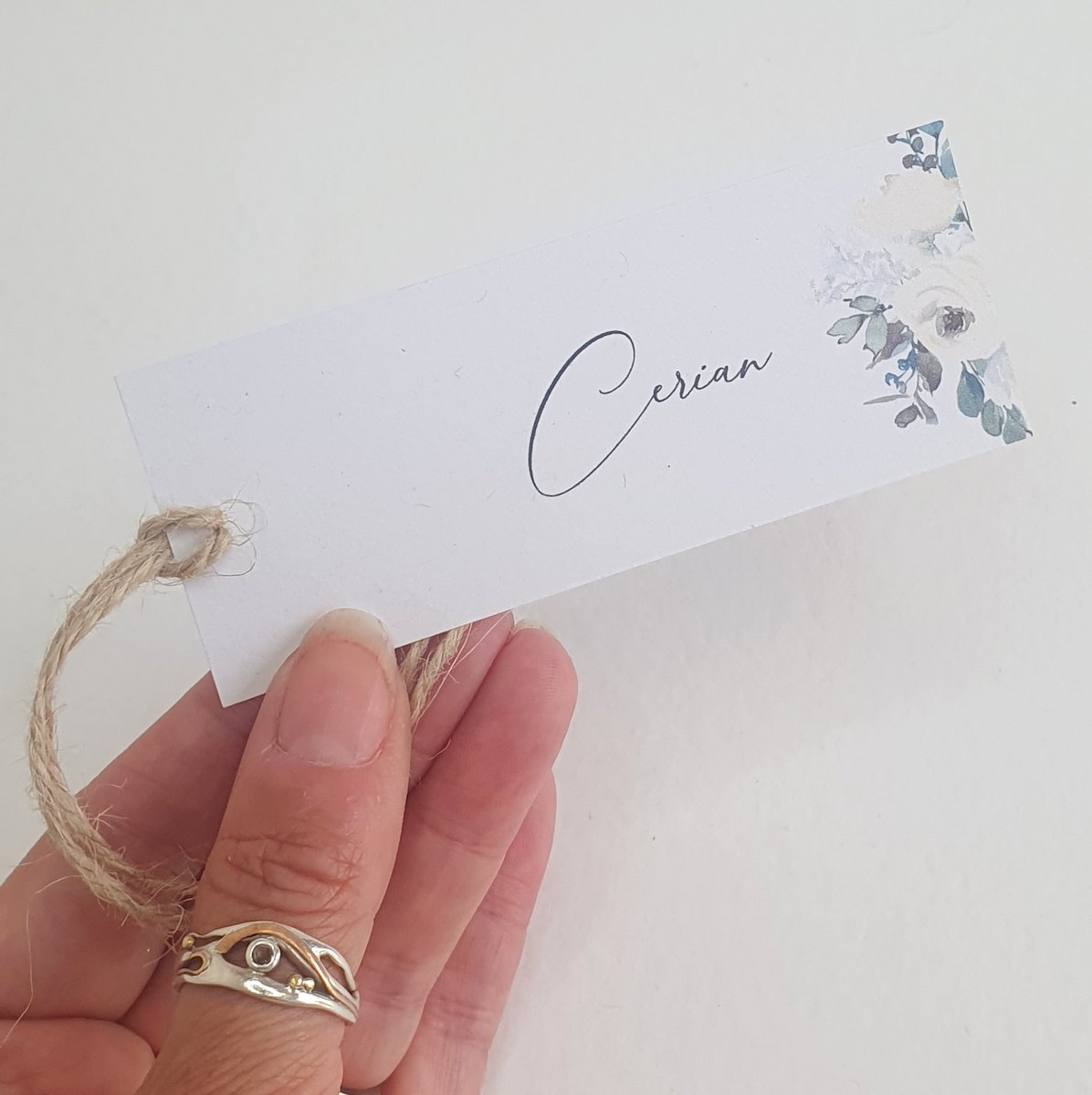 white and green floral wedding place tag with twine