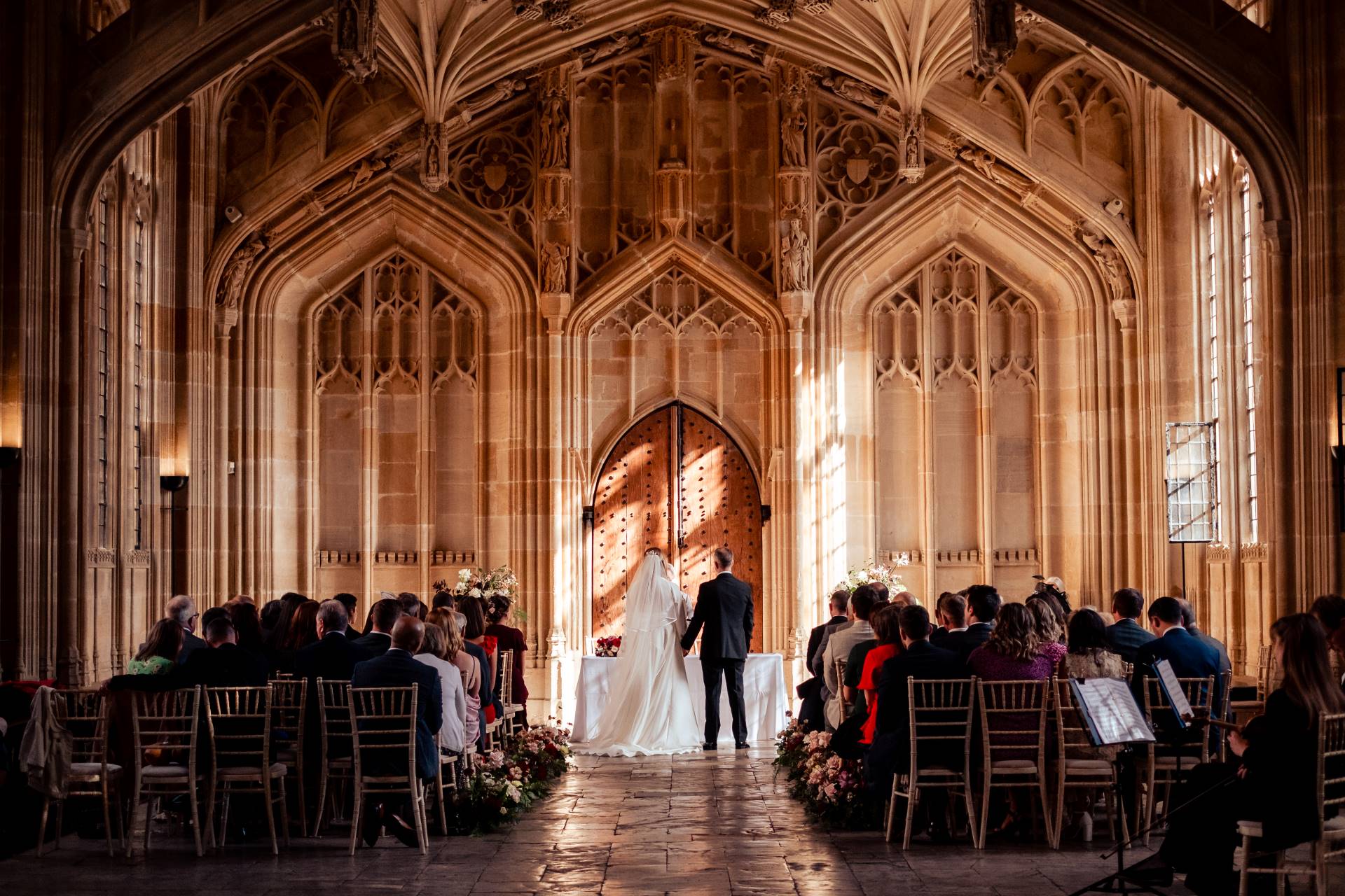 bride groom holding hands bodleian library oxford.jpg