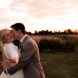 bride smiles groom kisses cheek sunset oxfordshire.jpg 260x260