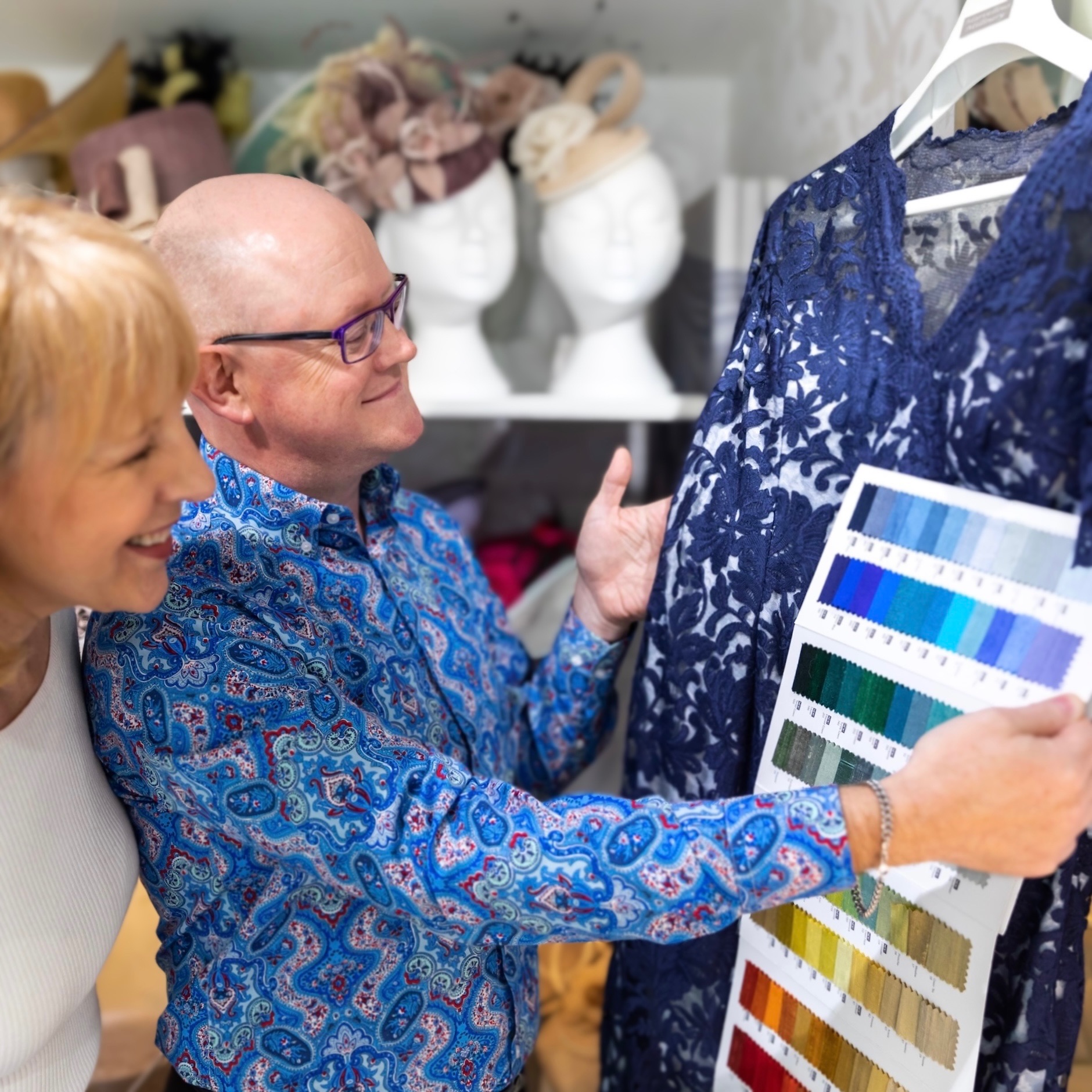 Simon offering his customer a variety of colour options for her bespoke wedding hat. Simon offering his customer a variety of colour options for her bespoke wedding hat.